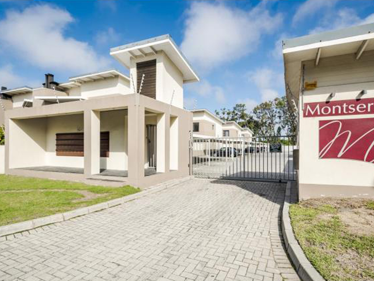 Modern secure entrance gatehouse of The Montserrat Estate townhouse complex, developed and built by Prism Construction